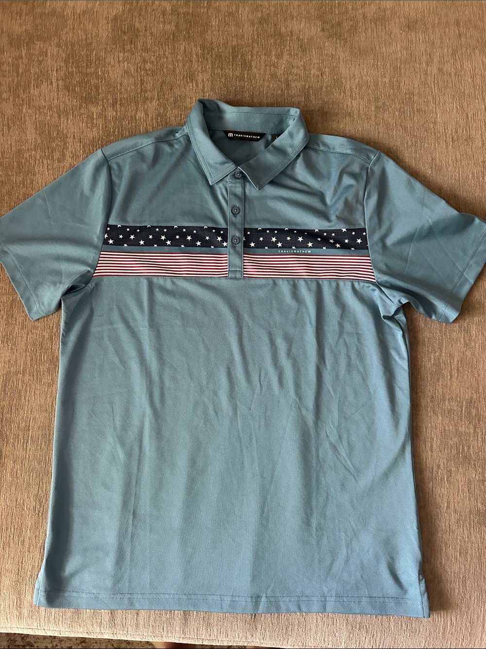 TravisMathew Teal Polo with Stars & Stripes Chest Panel